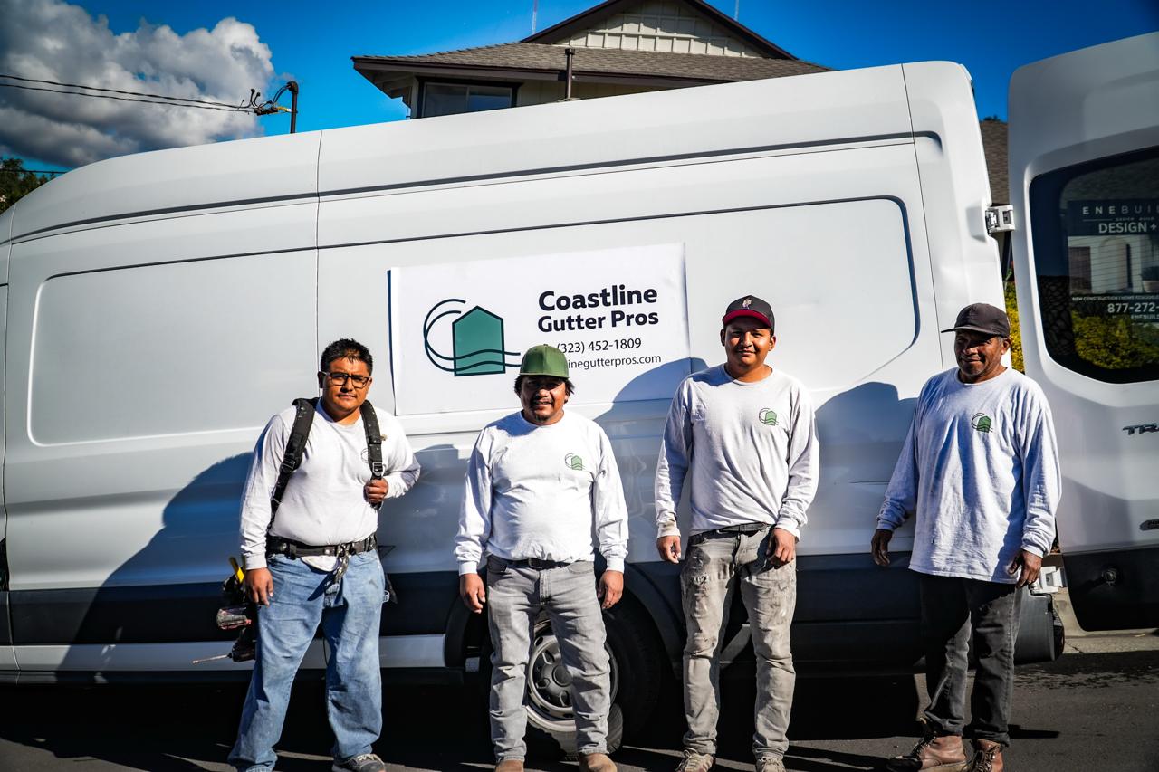 The Coastline Gutter Pros crew in front of a company Transit van in Los Angeles.